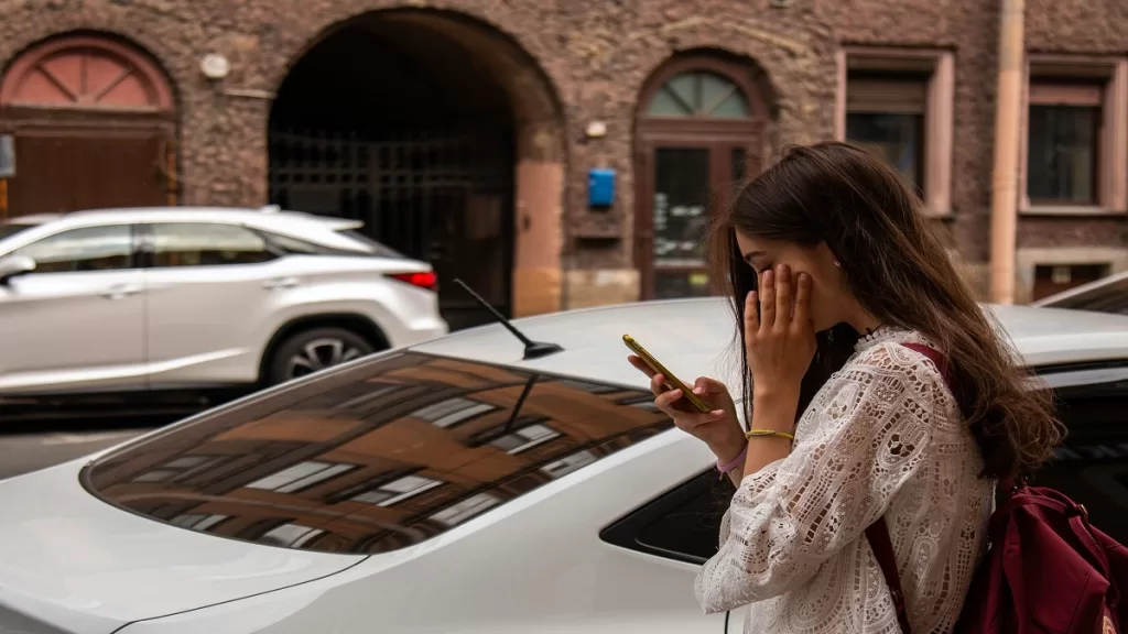 Woman on road looking at her phone