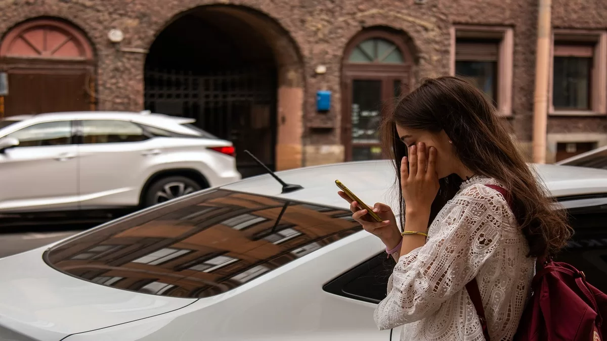 Woman on road looking at her phone